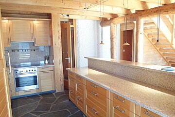 A kitchen with wooden cabinets and granite counter tops