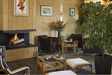 A living room with a fireplace and chairs