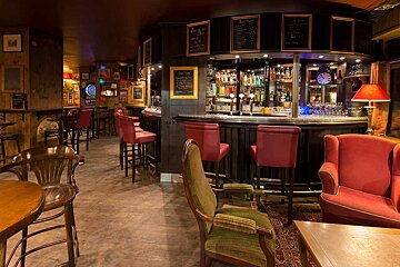 A bar with a chalkboard that says 