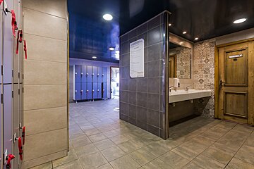 A bathroom with a sign on the wall that says