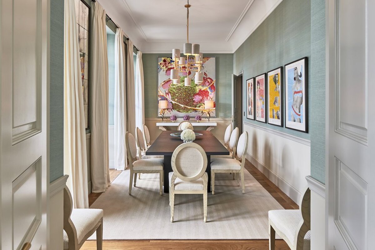 A dining room with a long table and chairs