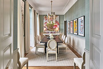 A dining room with a long table and chairs