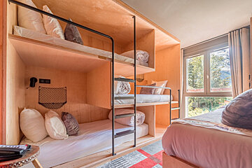 A bedroom with bunk beds and a window