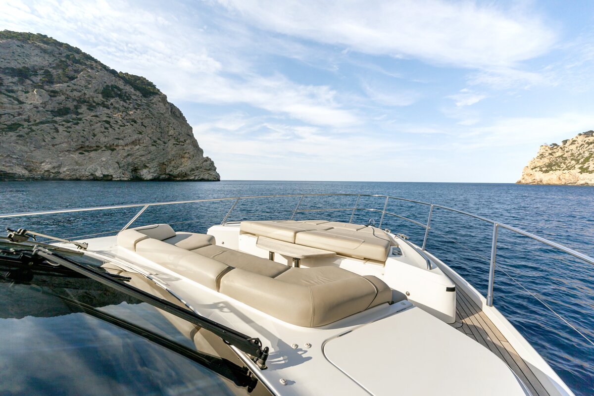 A boat in the ocean with a mountain in the background