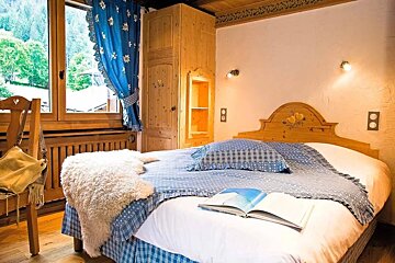 A bedroom with a bed and a book on it
