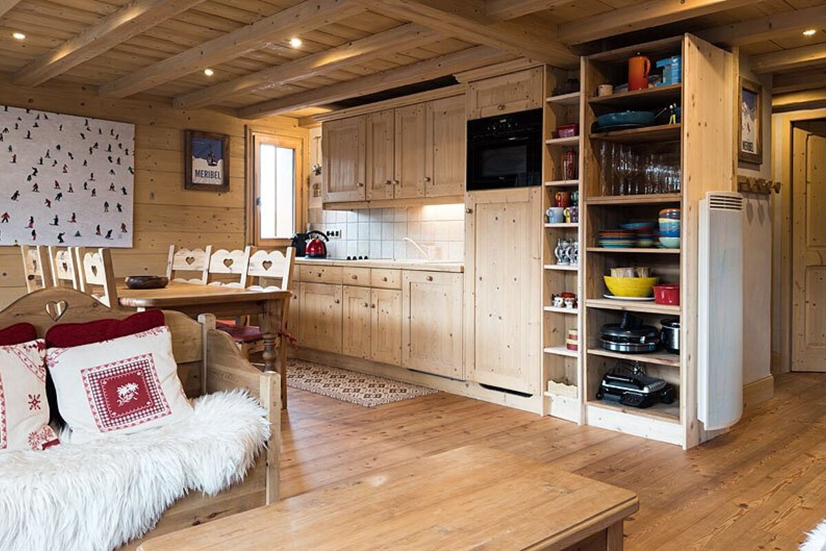 A kitchen with a picture of skiers on the wall