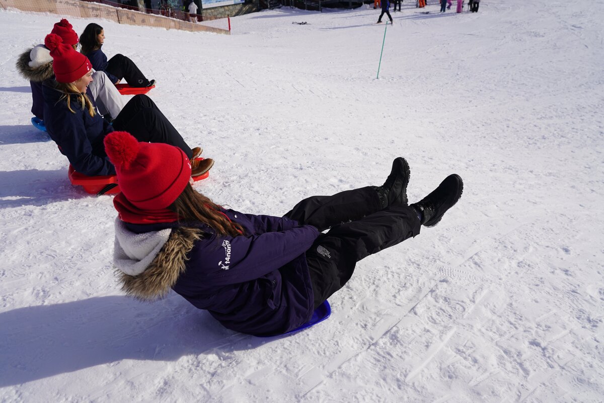 A person wearing a purple jacket that says ' abercrombie & fitch ' on it