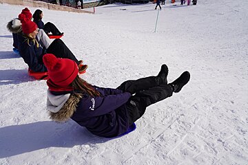 A person wearing a purple jacket that says ' abercrombie & fitch ' on it