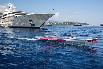 solar boat with yacht behind