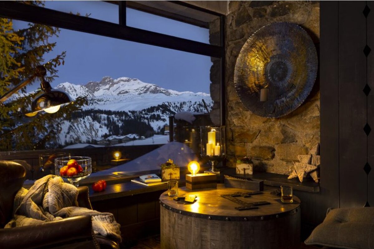 A living room with a view of a snowy mountain