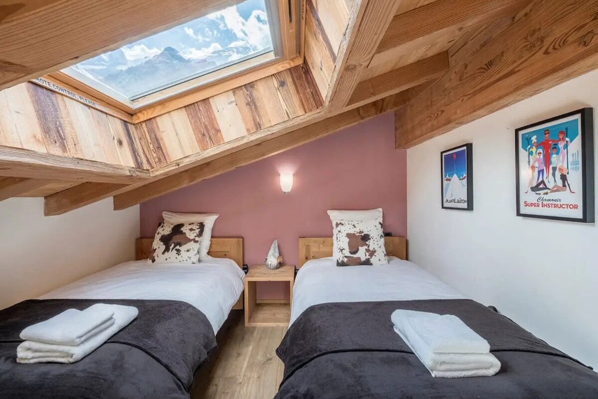 A bedroom with two beds and a poster that says super instructor