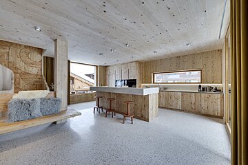 A kitchen with wooden cabinets and a marble counter top