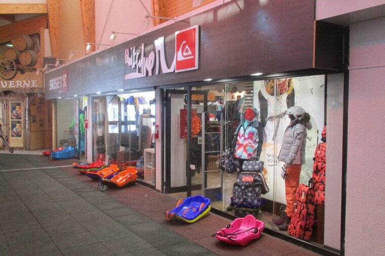 a shop with sledges out on the front