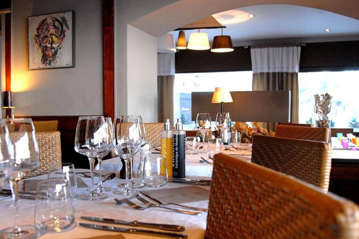 A restaurant setting with a bottle of the artisan de provence on the table