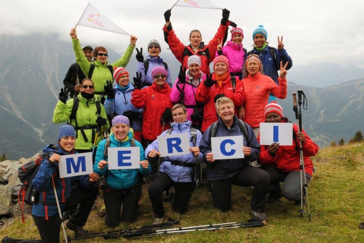 a group of charity workers holding a thank you sign