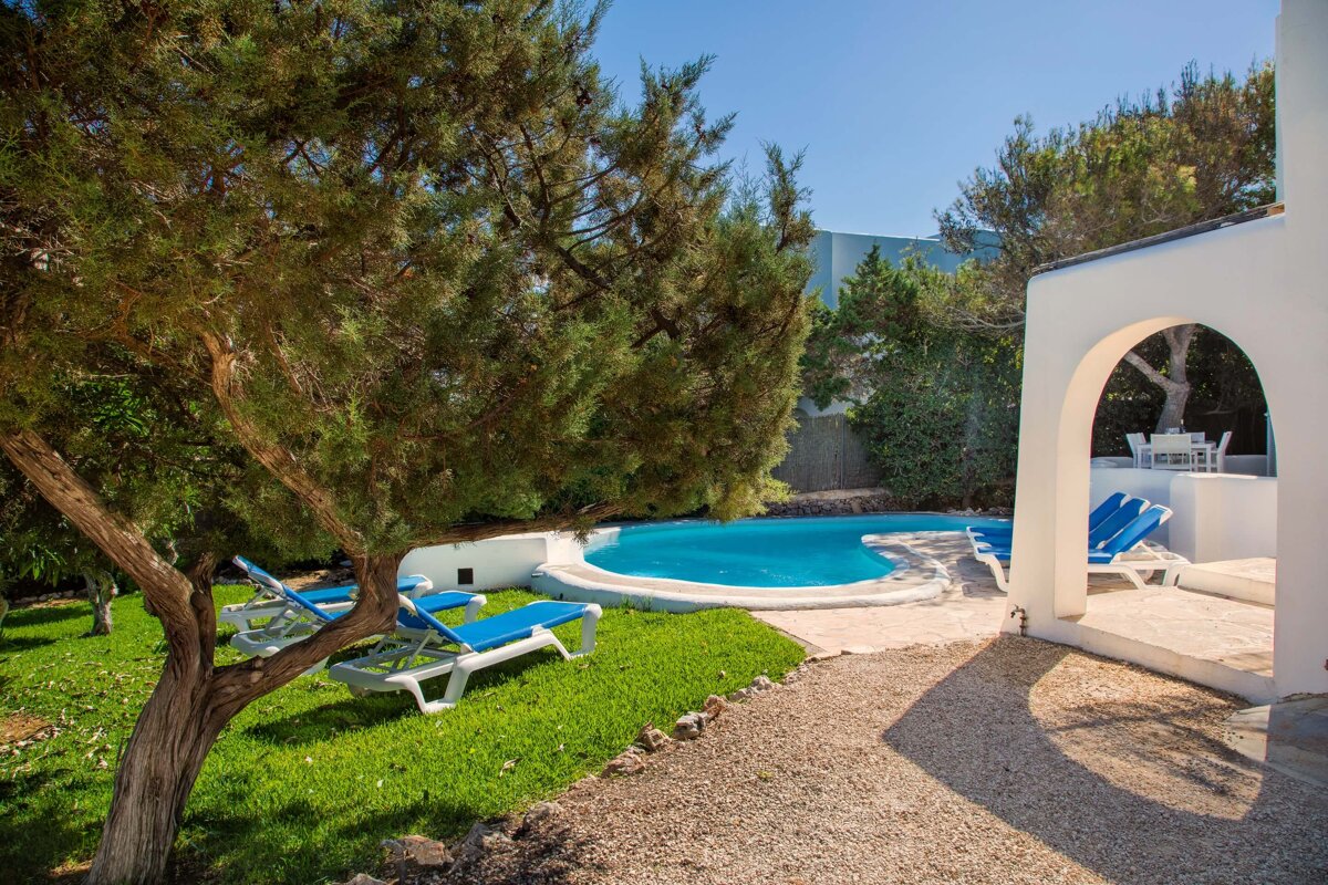 A white house with a swimming pool in the backyard