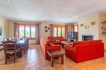 A living room with red couches and a television