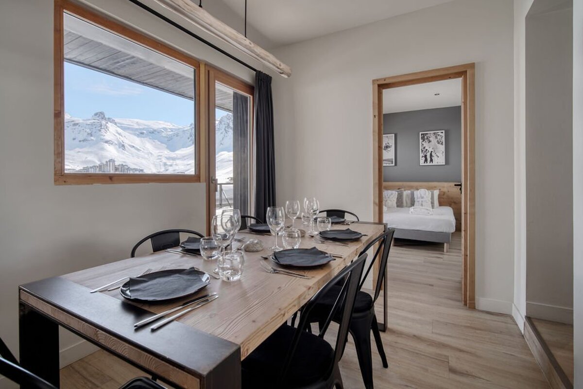 A dining room table with plates and glasses on it