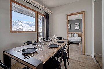 A dining room table with plates and glasses on it