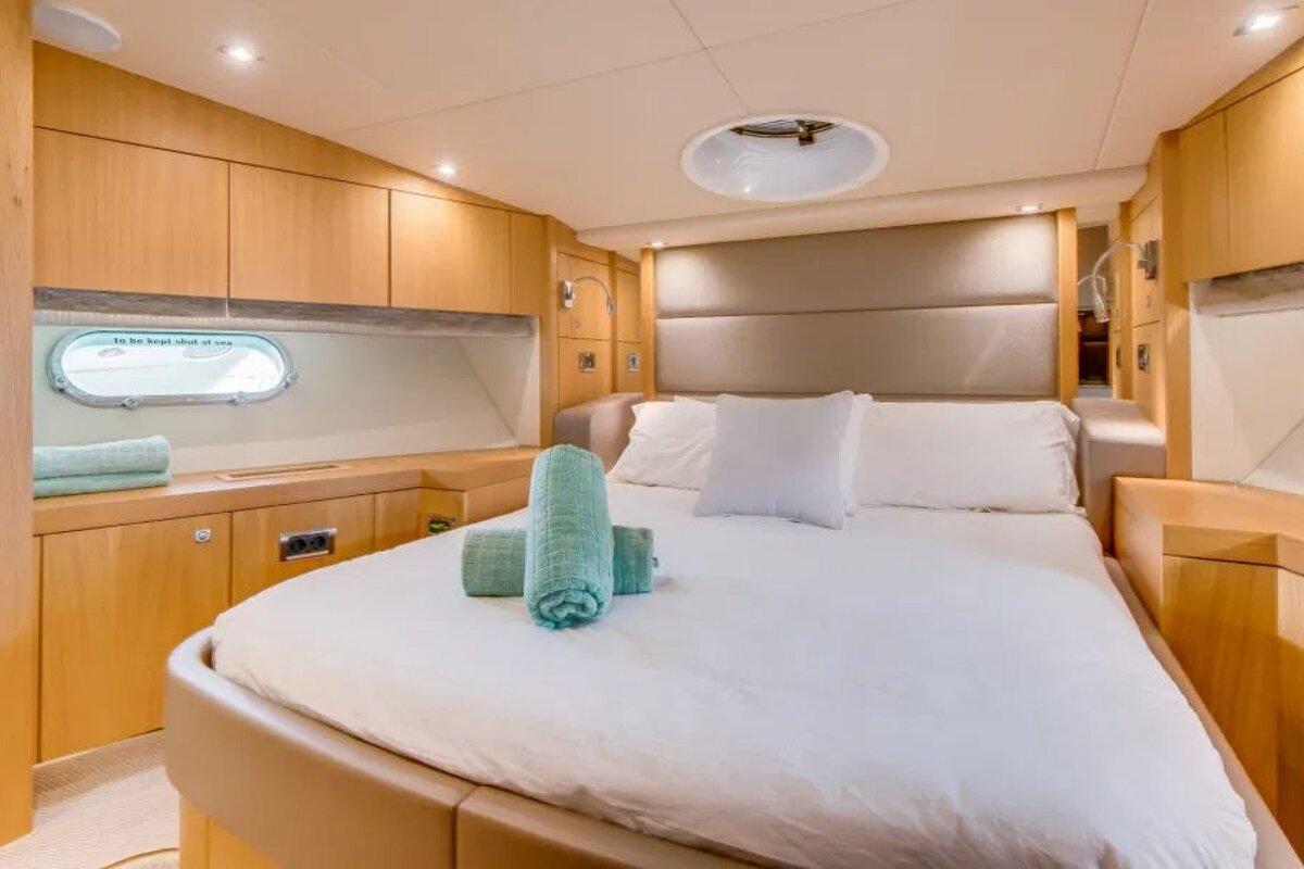 A bedroom on a boat with a window that says 