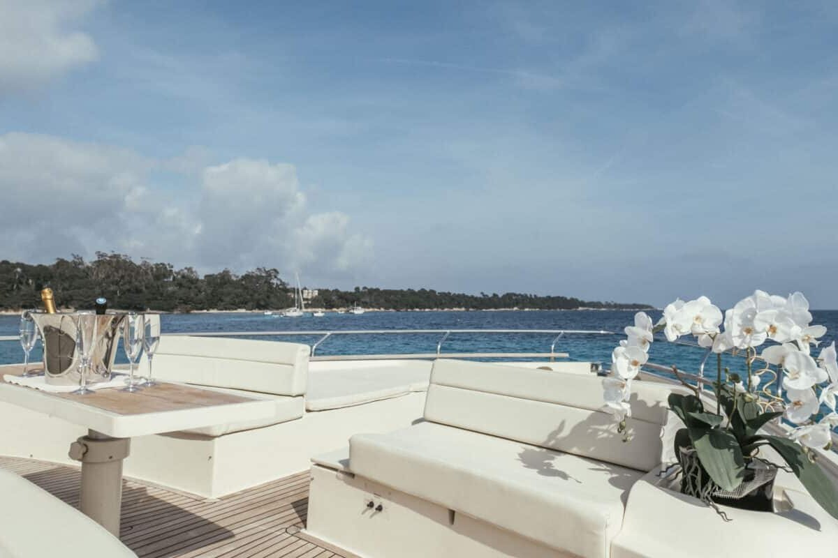 A boat with a table and a bottle of champagne on it