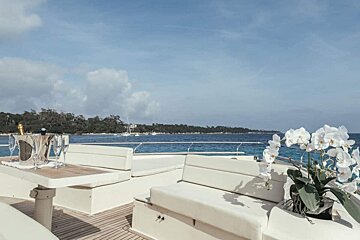 A boat with a table and a bottle of champagne on it