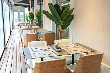 A row of tables and chairs in a restaurant