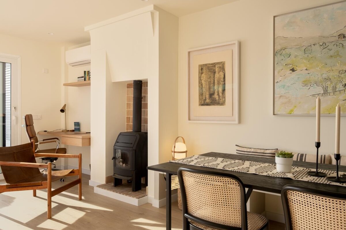 A room with a table and chairs and a painting on the wall