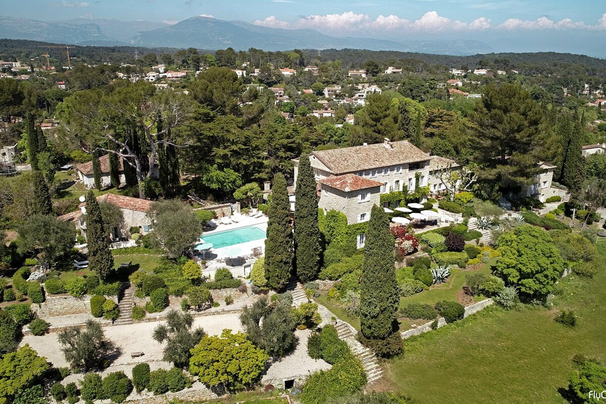 An aerial view of a large house with a pool