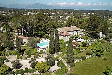 An aerial view of a large house with a pool
