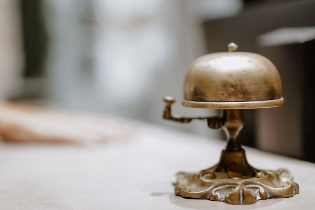 A small brass bell sits on a table