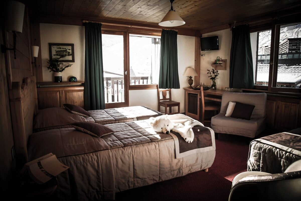 A hotel room with two beds and a chair