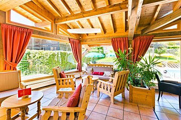A living room with wooden furniture and red curtains