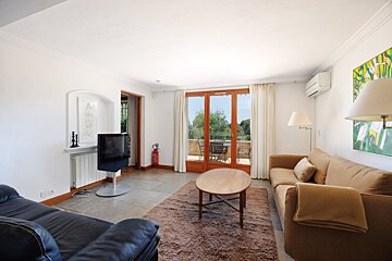 A living room with a couch and a flat screen tv