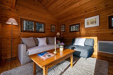 A living room with a couch and a book on a coffee table
