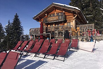A row of red chairs are lined up in front of a building that says passion