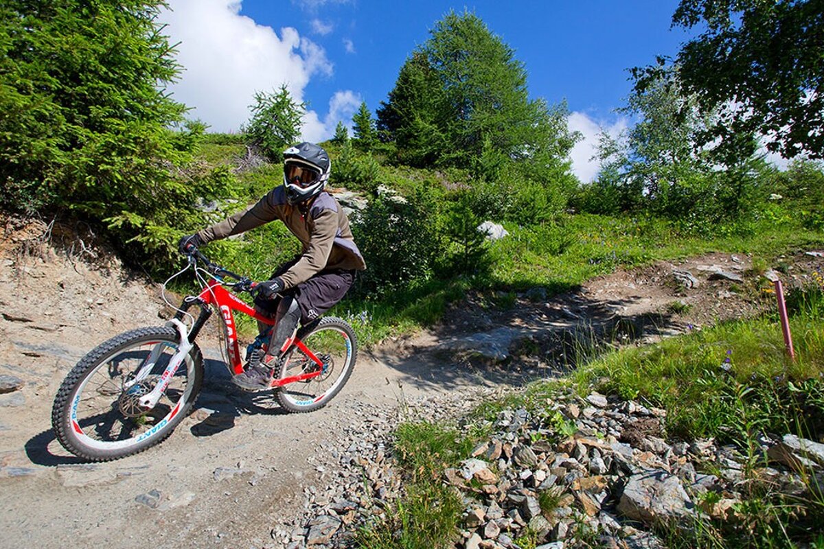 a female mountain biker on a trail in les arcs