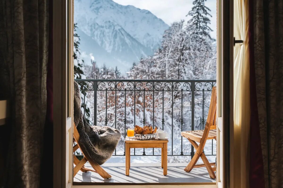 A balcony with a view of snow covered mountains