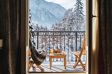 A balcony with a view of snow covered mountains