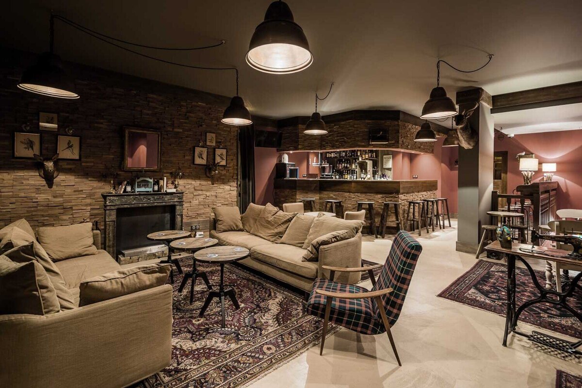 A living room with a couch and chairs and a fireplace