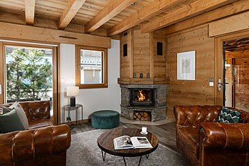 A living room with a fireplace and a book on a table