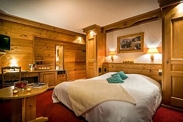 A hotel room with a bed and a picture on the wall