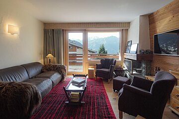 A living room with a couch and two chairs