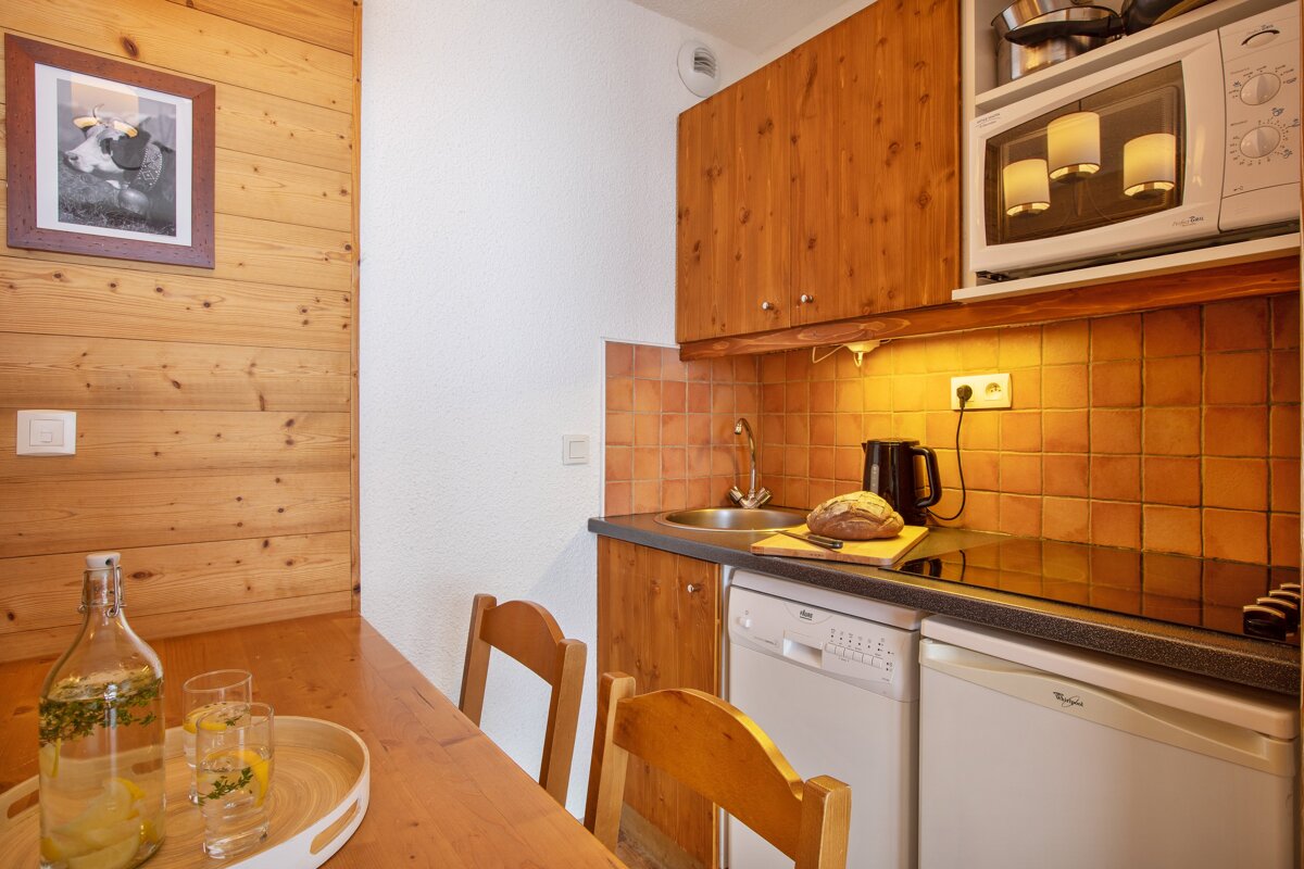 A kitchen with a whirlpool dishwasher and a microwave