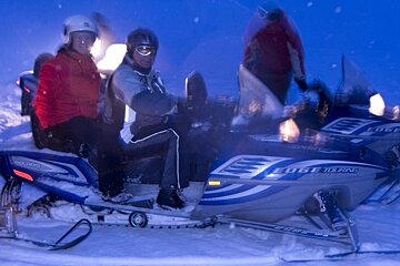 people on moto neige at night