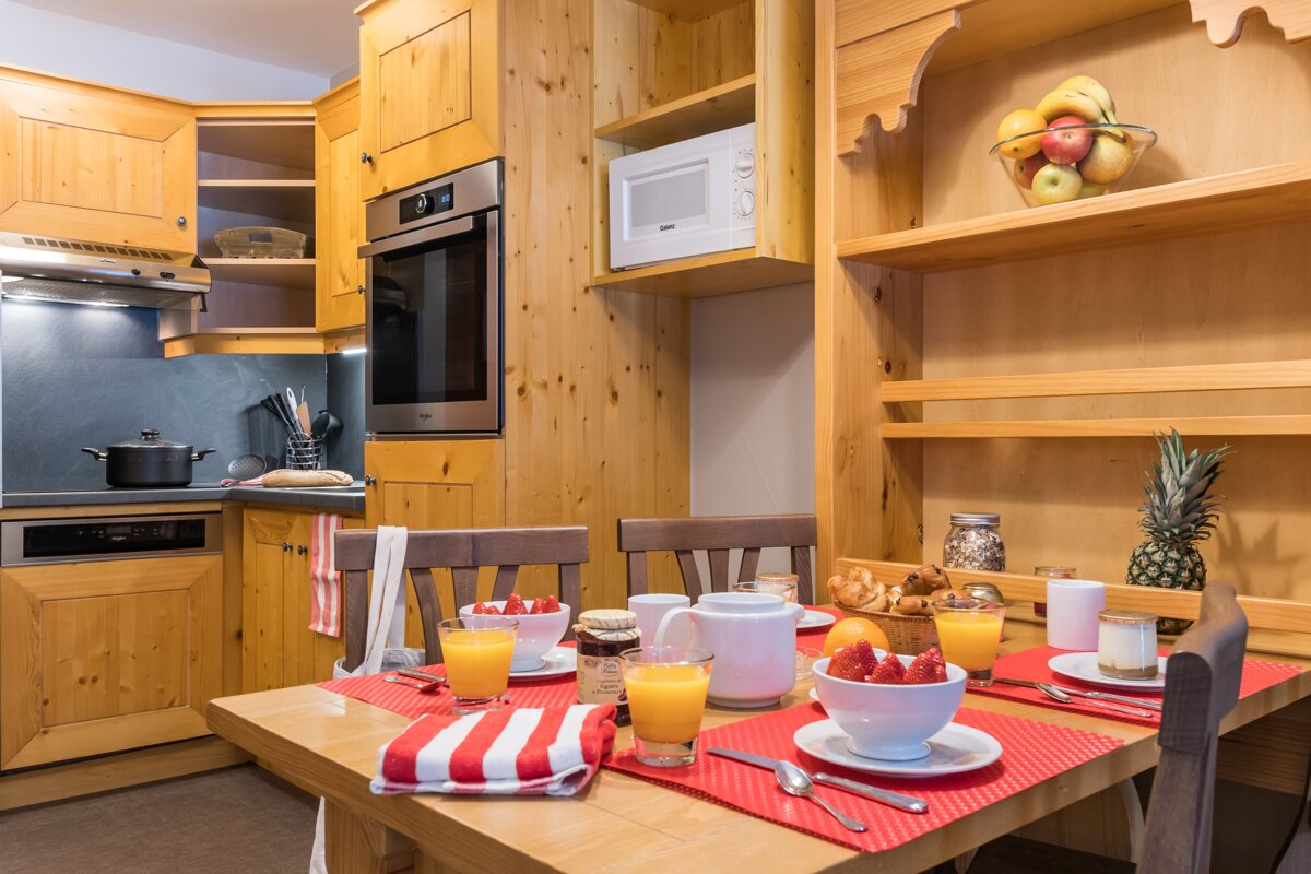 A kitchen with wooden cabinets and a microwave that says ' bosch ' on it