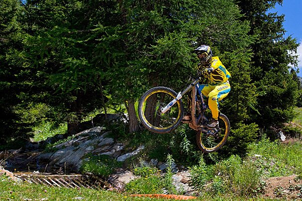 a mountain biker jumping over a river
