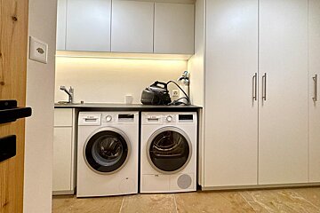 A laundry room with two bosch washers and dryers