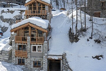 A snow covered building with a staircase leading up to it