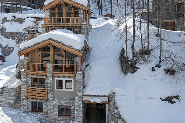 A snow covered building with a staircase leading up to it